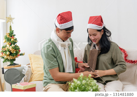 Christmas holiday brings joy, happy couple shares love at home, winter warmth felt, exchanging gifts celebrating christmas day together with festive tree. Christmas holiday brings joy, happy couple shares love at home, winter warmth felt, exchanging gifts celebrating christmas day together with festive tree. 131481880