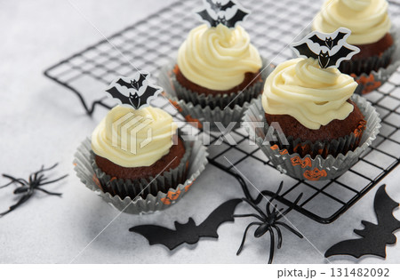 Halloween cupcakes with frosting and spooky bat decorations Halloween cupcakes with frosting and spooky bat decorations 131482092