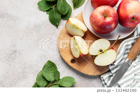 Fresh red apples slicing on wooden board 131482100