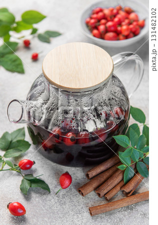 Rosehip tea brewing in glass teapot with cinnamon 131482102