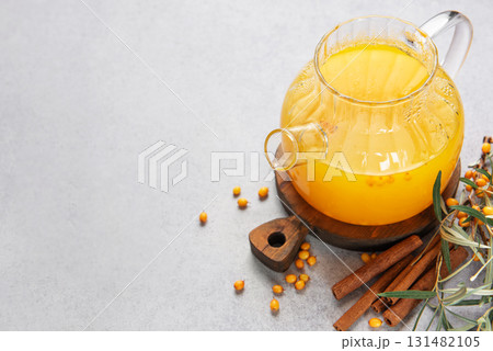 Sea buckthorn tea with cinnamon in a glass teapot Sea buckthorn tea with cinnamon in a glass teapot 131482105