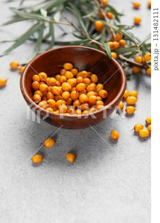 Sea buckthorn berries in bowl, harvesting healthy superfood 131482111