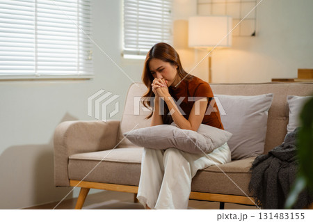 Sad and depressed young asian female sitting on the floor in the room, sad mood, feel tired, lonely and unhappy concept. Selective focus. Sad and depressed young asian female sitting on the floor in the room, sad mood, feel tired, lonely and unhappy concept. Selective focus. 131483155