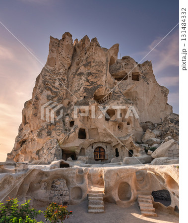 Uchisar Castle, a stunning rock-cut fortress and cave village in Cappadocia, Turkey, at sunset 131484332