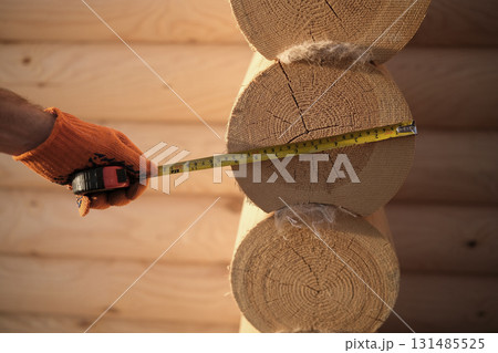 Construction of a house from rounded logs Construction of a house from rounded logs 131485525