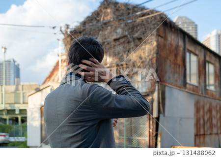 空き家を見つめる男性 131488062