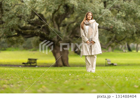 Young woman standing in park enjoying nature 131488404