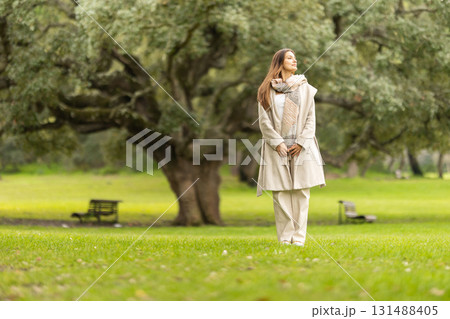 Young woman enjoying peaceful moment in park nature 131488405