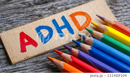 ADHD AUTISM written with colored pencils on wooden background. 131489104