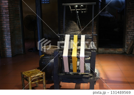 Separate silk worm via spinning wheel, Thai wisdom. process highlights sustainable textile making, natural materials, and the dedication in rural workshops. 131489569