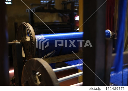 Separate silk worm via spinning wheel, Thai wisdom. process highlights sustainable textile making, natural materials, and the dedication in rural workshops. 131489573