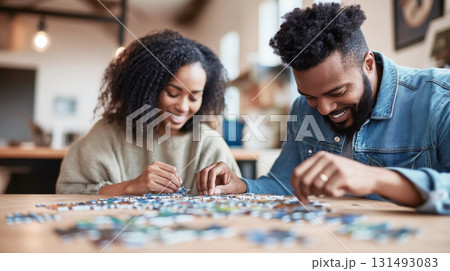 Young african american couple enjoying puzzle hobby at home, background Young african american couple enjoying puzzle hobby at home, background 131493083