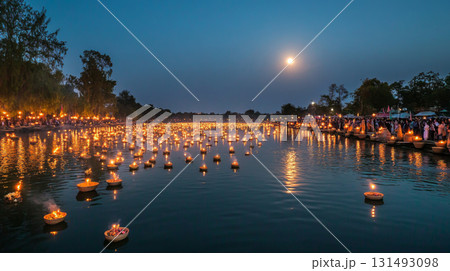 Asian festival Yi Peng lanterns floating on water at night, background 131493098