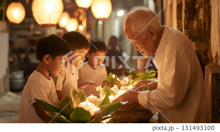 Celebrating Loy Krathong Thai family with children preparing kratongs together 131493100