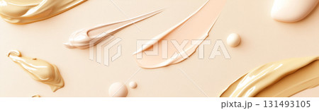 Fluid cosmetics textures featuring spread highlighter and foundation cream 131493105