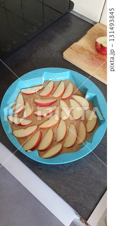 Preparing apple pie in a silicone mold at home before baking, mobile photo. Concept of cooking, dessert, homemade, authenticity. Preparing apple pie in a silicone mold at home before baking, mobile photo. Concept of cooking, dessert, homemade, authenticity. 131493845