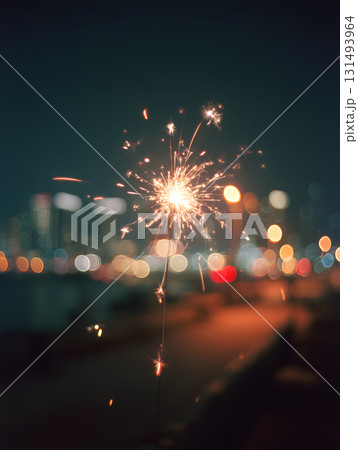 Firework is lit up in the night sky, with the city lights in the background Firework is lit up in the night sky, with the city lights in the background 131493964