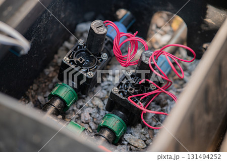 Detailed CloseUp View of Irrigation Control Valves Located Inside a Utility Box 131494252