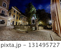 Tallinn Old Town cobblestone street with historic buildings and Tiny chapel at night 131495727