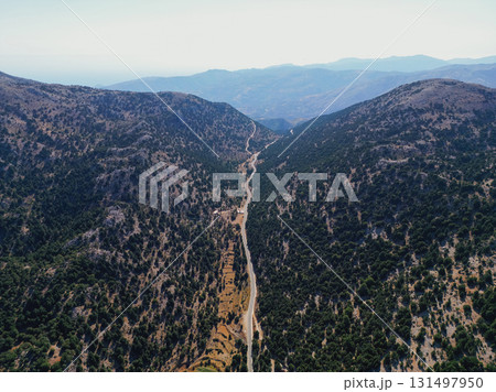 Long mountain road along forest in Crete, aerial drone photo. Long mountain road along forest in Crete, aerial drone photo. 131497950