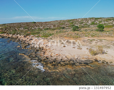 Rocky coastline on Crete island with crystal clear azure sea water under the summer sun. 131497952