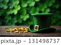 Green hat with gold buckle lies on table next to pile of gold coins on green background. St. Patrick 131498737