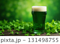 Glass of green foamy irish beer stands on green grassy clover background. St. Patrick Day 131498755