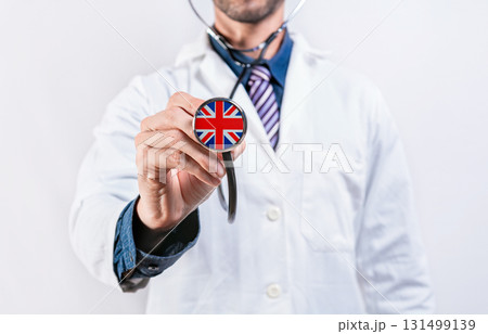 United Kingdom healthcare system, doctor holding stethoscope. United Kingdom health and medical insurance concept 131499139