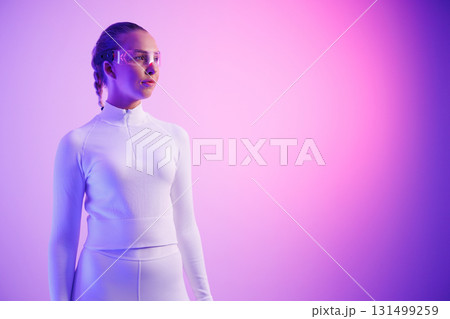 Woman in smartglasses standing against purple background Woman in smartglasses standing against purple background 131499259