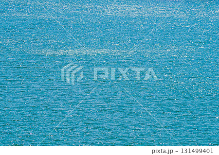 A view of the surface of the ocean or the sea with a water surface with waves with a fading perspective up the frame, there are light highlights from sunlight. Unique natural spaces 131499401
