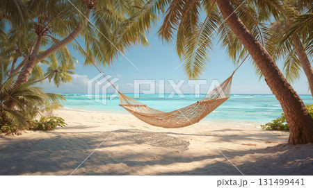 Relaxing on a tropical beach with a hammock swaying gently between palm trees under a clear blue sky 131499441