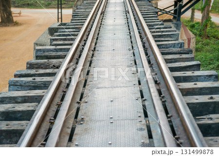 Old rail track with wooden sleepers and rusty rails 131499878