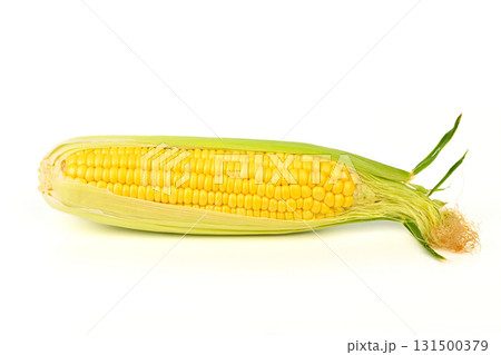 A yellow corn cob with green leaves 131500379