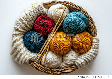 Ready to Create. Top view. Vibrant yarn skeins arranged neatly beside knitting needles. Ready to Create. Top view. Vibrant yarn skeins arranged neatly beside knitting needles. 131500583
