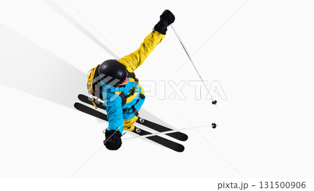Skier captured from above extending arms wide in dynamic aerial pose 131500906