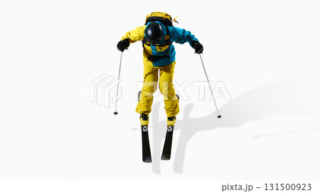 Male skier in blue and yellow uniform jumping with poles isolated on white background 131500923