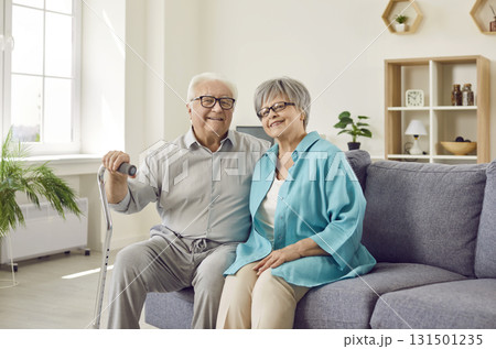 Happy senior family couple wife and husband sitting on sofa in the living room at home. Happy senior family couple wife and husband sitting on sofa in the living room at home. 131501235