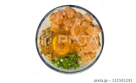 Delicious salmon donburi served over rice with raw egg yolk, crispy fried shallot, and fresh green onion. 131501291