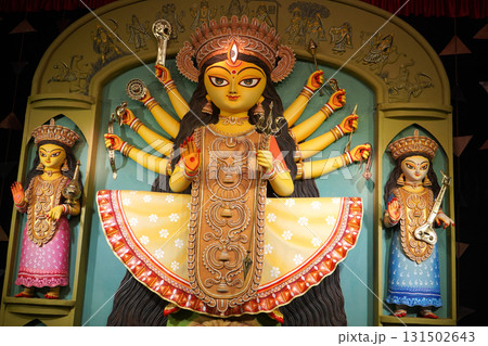 Traditional Bengali Idol of Goddess Durga and Children in a Colorful Pandal Display Traditional Bengali Idol of Goddess Durga and Children in a Colorful Pandal Display 131502643