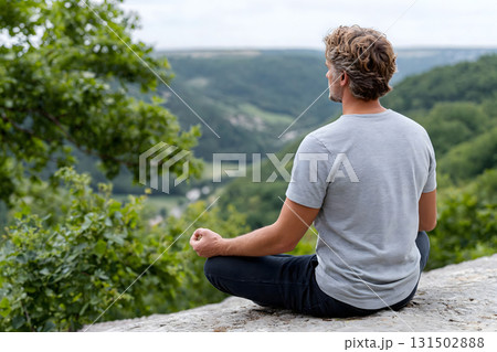 Man Meditating Outdoors by the River in Nature Man Meditating Outdoors by the River in Nature 131502888