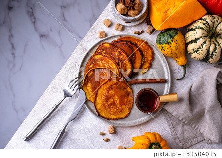 Pumpkin pancakes with maple syrup 131504015