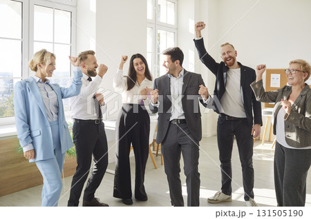 Portrait of a group of joyful happy business people men and women having fun standing in office. Portrait of a group of joyful happy business people men and women having fun standing in office. 131505190