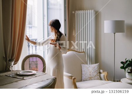 Woman drinking tea contemplating a Parisian morning view 131506159