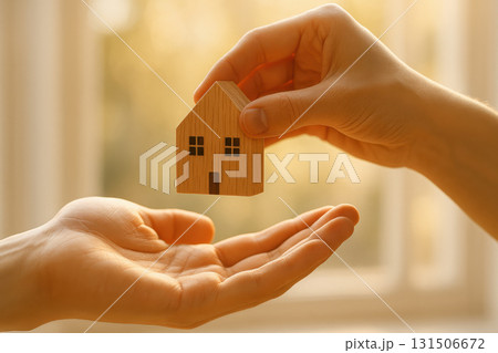 Wooden house miniature hand holding house open hand property transfer mortgage approval sunlight background real estate concept home ownership small house model warm light 131506672