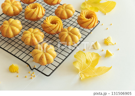 Autumn-Themed Mini pumpkin Cakes with Seasonal Decorations on White Background Autumn-Themed Mini pumpkin Cakes with Seasonal Decorations on White Background 131506905