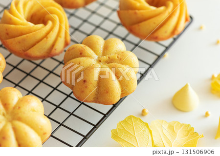 Autumn-Themed Mini pumpkin Cakes with Seasonal Decorations on White Background Autumn-Themed Mini pumpkin Cakes with Seasonal Decorations on White Background 131506906