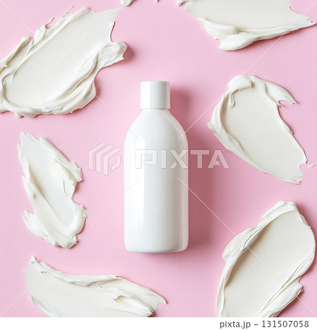 Skincare Product Bottle on Pink Background with Cream Splatters Skincare Product Bottle on Pink Background with Cream Splatters 131507058