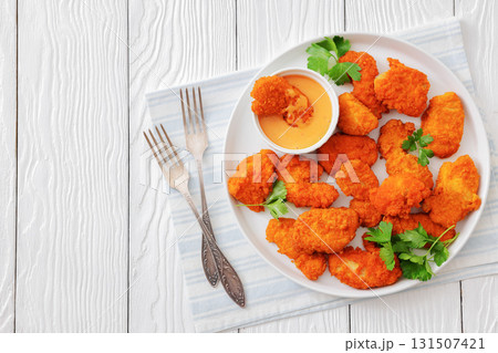 breaded chicken breast chunks with dipping sauce breaded chicken breast chunks with dipping sauce 131507421