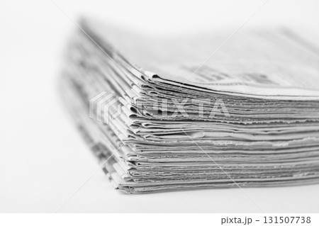Pile of old newspapers on white background. Black and white photo. 131507738
