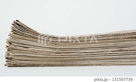 Stack of daily newspapers on a table. Pile of business papers on white background Stack of daily newspapers on a table. Pile of business papers on white background 131507739